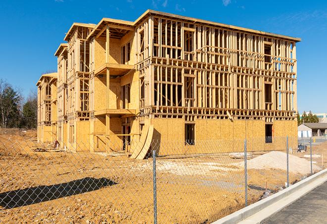 a close-up of temporary chain link fences enclosing a job site, signaling progress in the project's development in Verona